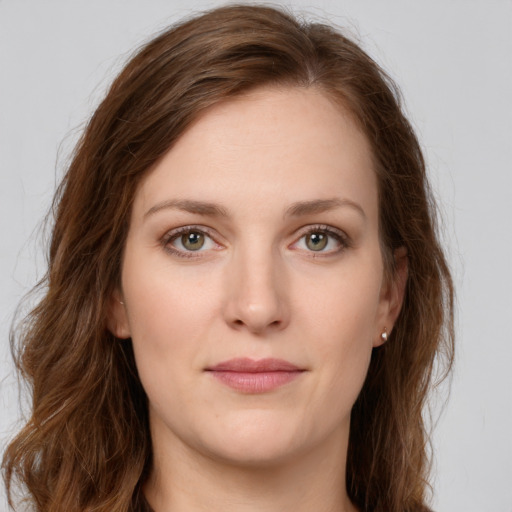 Joyful white young-adult female with long  brown hair and green eyes