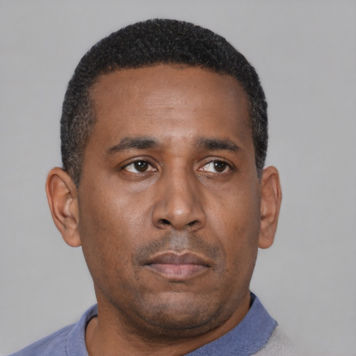 Neutral latino adult male with short  black hair and brown eyes