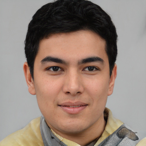 Joyful asian young-adult male with short  black hair and brown eyes