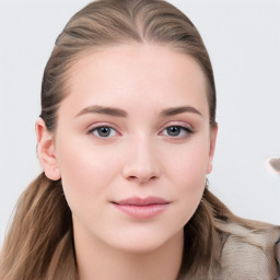 Joyful white young-adult female with long  brown hair and blue eyes