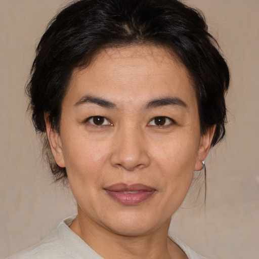 Joyful white adult female with medium  brown hair and brown eyes