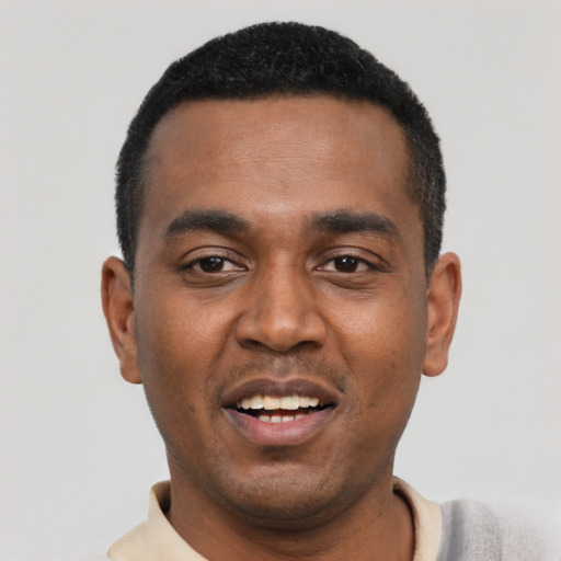 Joyful black young-adult male with short  black hair and brown eyes