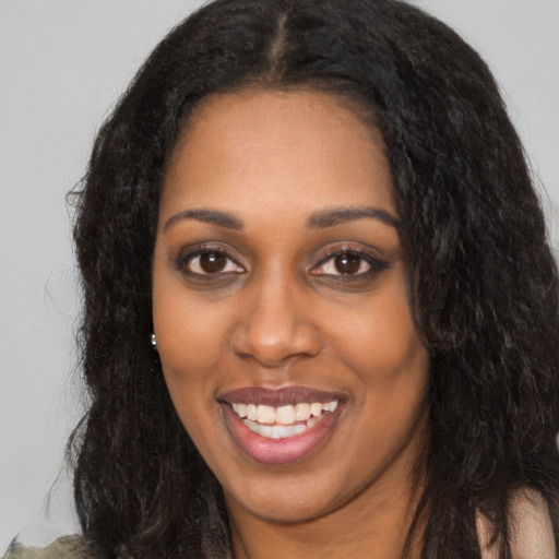Joyful latino young-adult female with long  black hair and brown eyes