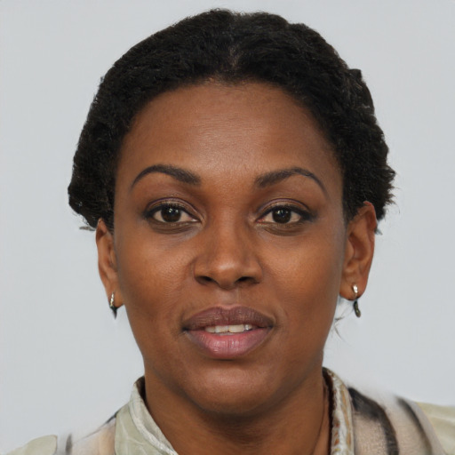 Joyful black adult female with short  brown hair and brown eyes