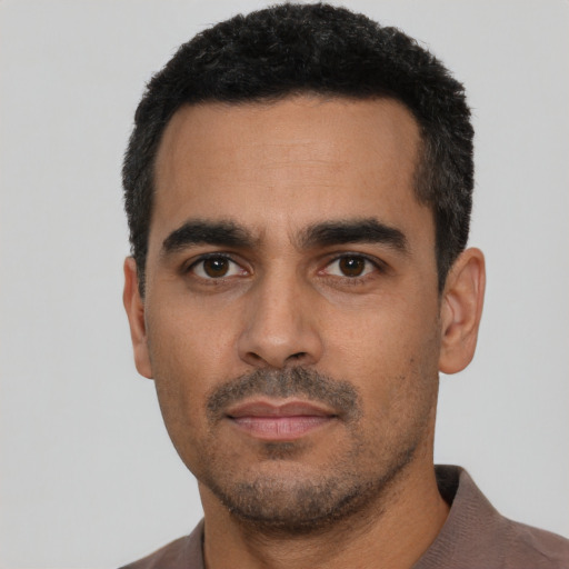 Neutral latino young-adult male with short  black hair and brown eyes