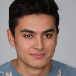 Joyful latino young-adult male with short  brown hair and brown eyes