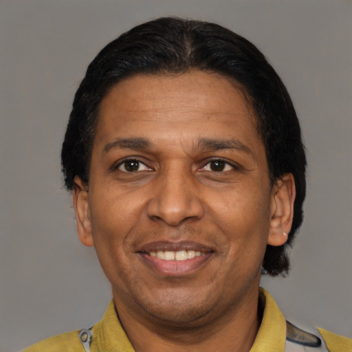 Joyful latino adult male with short  brown hair and brown eyes