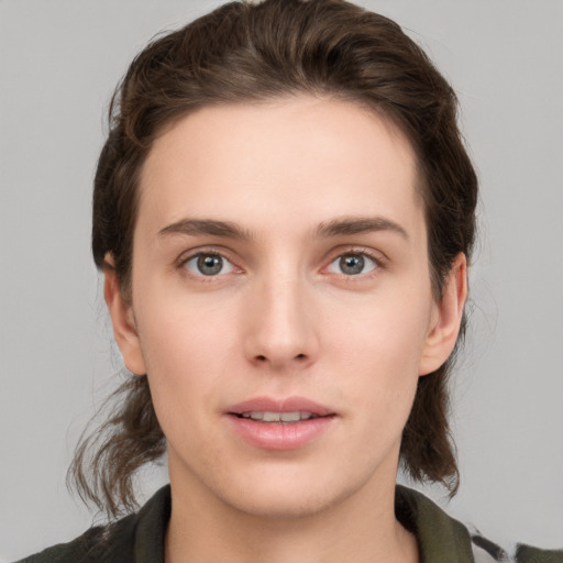 Joyful white young-adult female with medium  brown hair and green eyes