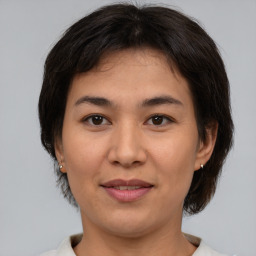 Joyful asian young-adult female with medium  brown hair and brown eyes