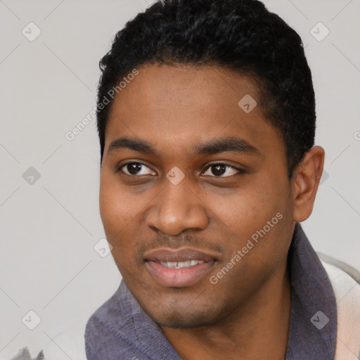 Joyful black young-adult male with short  black hair and brown eyes