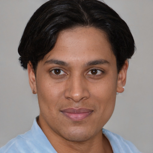 Joyful asian adult male with short  brown hair and brown eyes