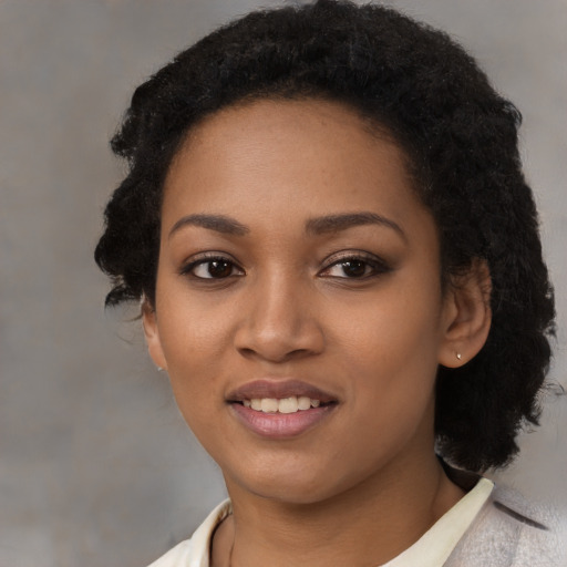 Joyful black young-adult female with medium  black hair and brown eyes