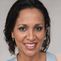 Joyful black adult female with medium  brown hair and brown eyes