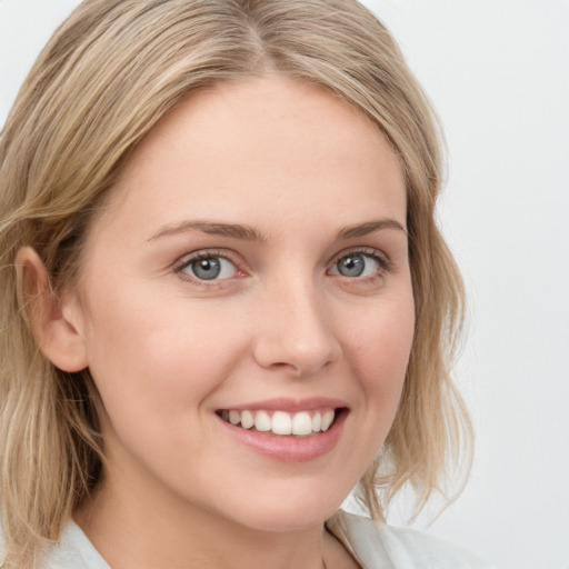 Joyful white young-adult female with medium  brown hair and blue eyes