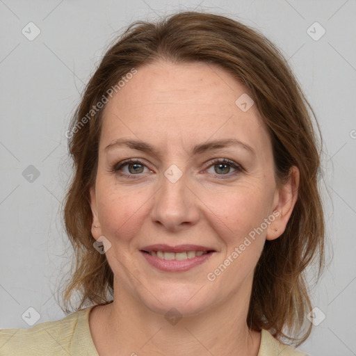 Joyful white adult female with medium  brown hair and grey eyes