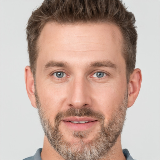 Joyful white adult male with short  brown hair and brown eyes