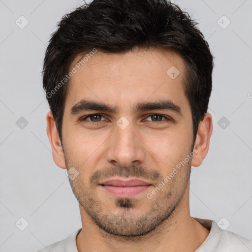 Joyful white young-adult male with short  black hair and brown eyes