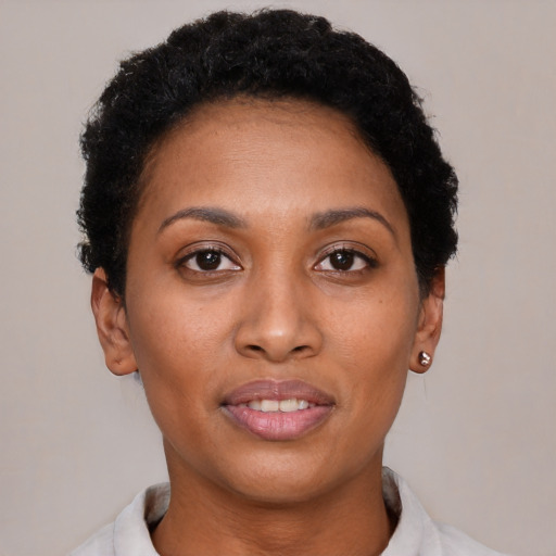 Joyful black young-adult female with short  brown hair and brown eyes