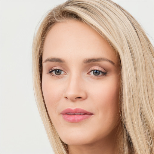 Joyful white young-adult female with long  brown hair and blue eyes