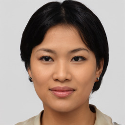 Joyful asian young-adult female with short  black hair and brown eyes