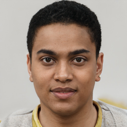 Joyful black young-adult male with short  black hair and brown eyes