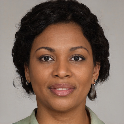 Joyful black young-adult female with medium  brown hair and brown eyes