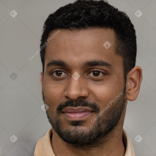 Joyful black young-adult male with short  black hair and brown eyes