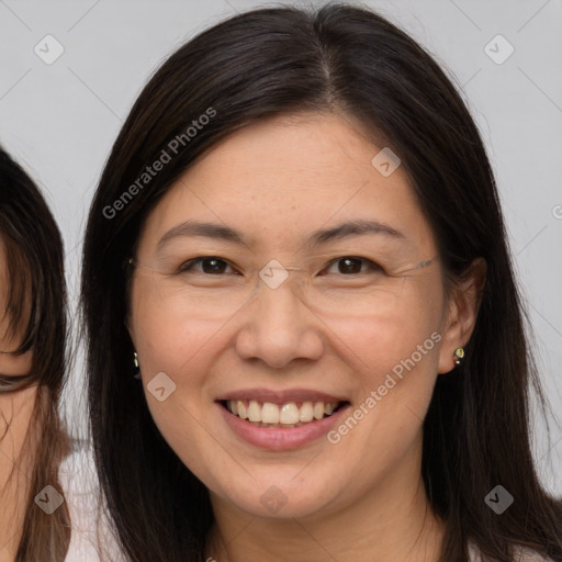 Joyful white adult female with long  brown hair and brown eyes