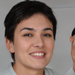 Joyful white young-adult female with short  brown hair and brown eyes