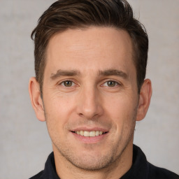 Joyful white adult male with short  brown hair and brown eyes