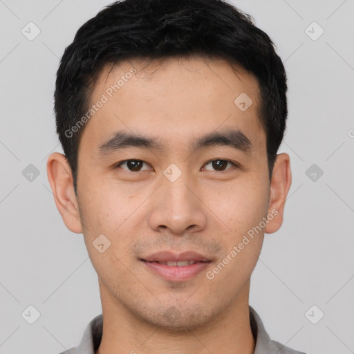 Joyful asian young-adult male with short  black hair and brown eyes