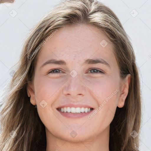 Joyful white young-adult female with long  brown hair and grey eyes