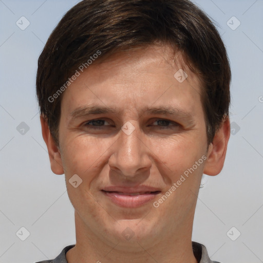 Joyful white adult male with short  brown hair and brown eyes