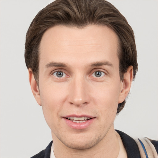 Joyful white adult male with short  brown hair and grey eyes