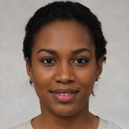 Joyful black young-adult female with short  brown hair and brown eyes