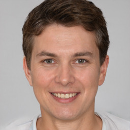 Joyful white adult male with short  brown hair and brown eyes