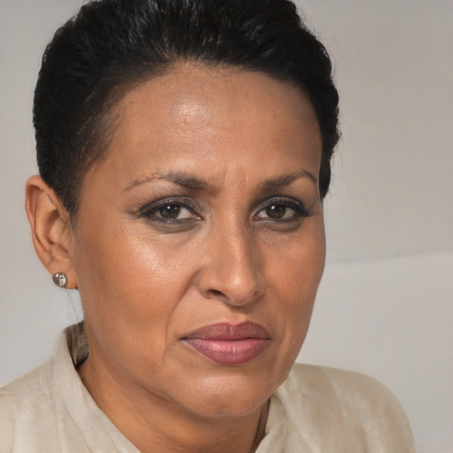 Joyful latino adult female with short  brown hair and brown eyes