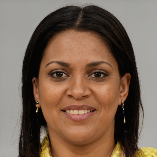 Joyful latino adult female with long  brown hair and brown eyes