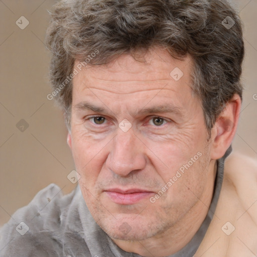 Joyful white middle-aged male with short  brown hair and brown eyes