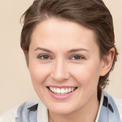 Joyful white young-adult female with medium  brown hair and grey eyes