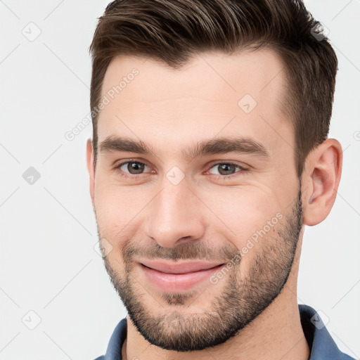 Joyful white young-adult male with short  brown hair and brown eyes