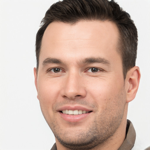 Joyful white young-adult male with short  brown hair and brown eyes