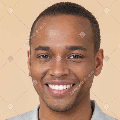 Joyful black young-adult male with short  brown hair and brown eyes