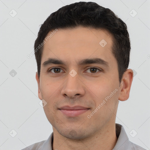 Joyful white young-adult male with short  black hair and brown eyes