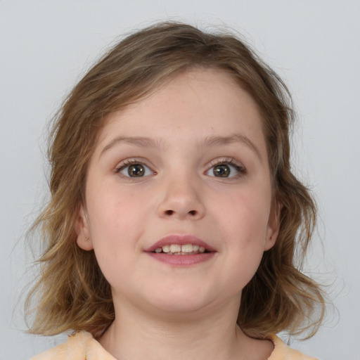 Joyful white child female with medium  brown hair and blue eyes