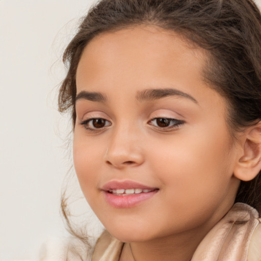 Joyful white child female with long  brown hair and brown eyes