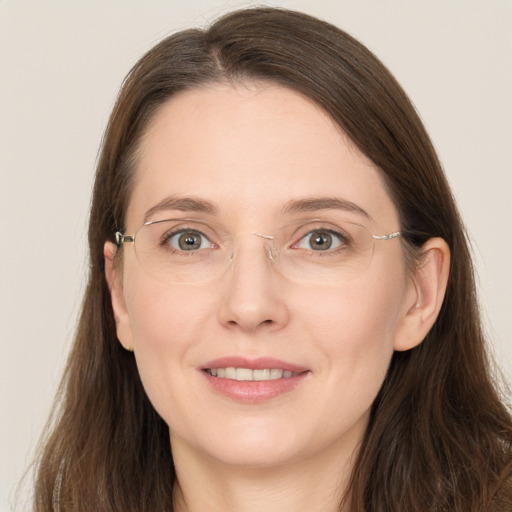 Joyful white adult female with long  brown hair and grey eyes