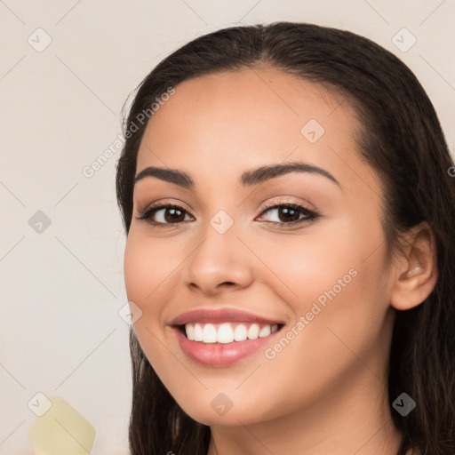 Joyful white young-adult female with long  brown hair and brown eyes