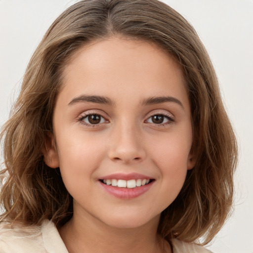 Joyful white child female with long  brown hair and brown eyes