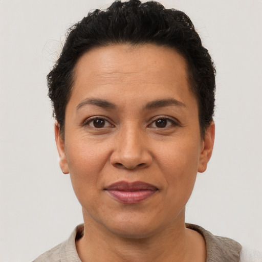 Joyful latino adult female with short  brown hair and brown eyes